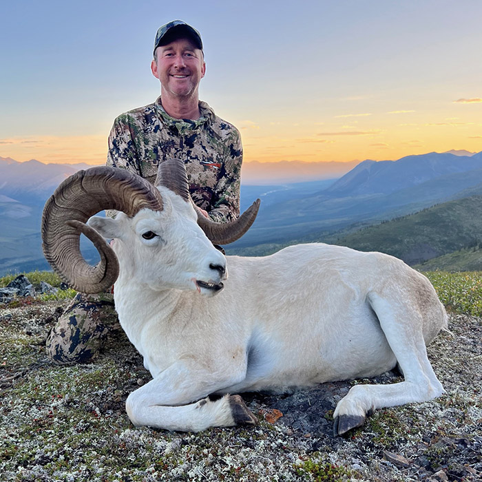 Hunter in camo with a Dall's sheep ram